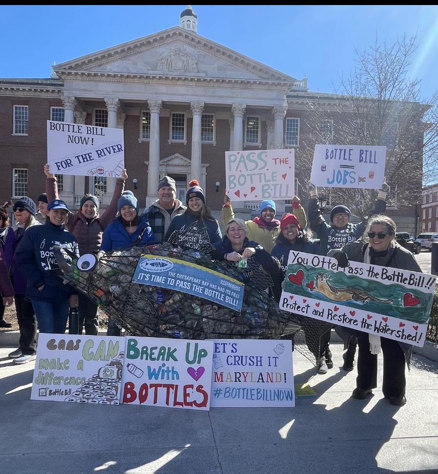 staff of aws in front of maryland legislature building, holding signs